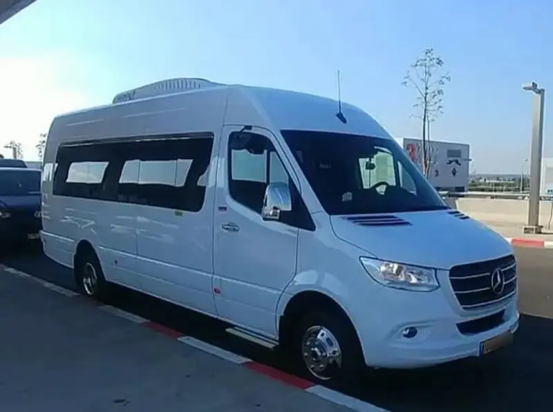 איסוף מנתב''ג לכל יעד - חזית נוספת מיניבוס מפואר לבן ממתין לאיסוף לקוחות מנתב''ג.